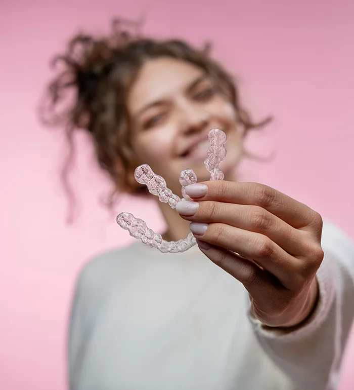 Girl Holding Invisalign Clear Aligners Trays