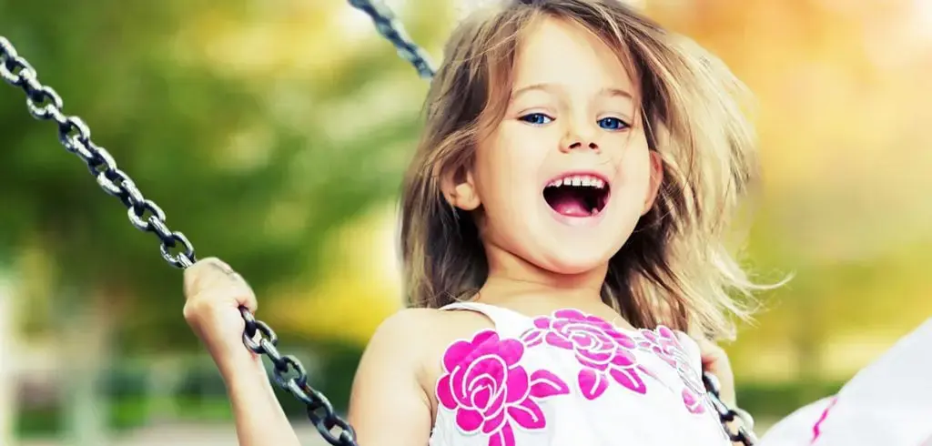 Girl In Swing Smiling