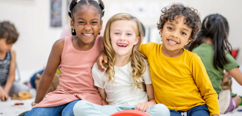Three Kids With Special Needs Smiling